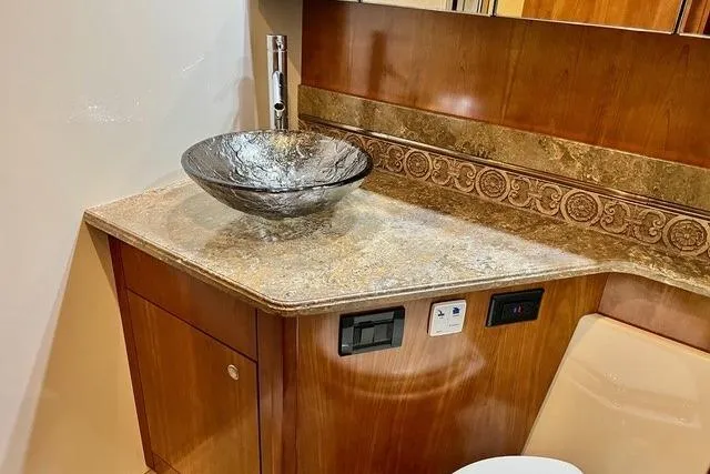 Slide: The Image of Luxurious bathroom interior of 2009 CRUISERS YACHT 520SC with elegant glass sink and wood finish. - 12