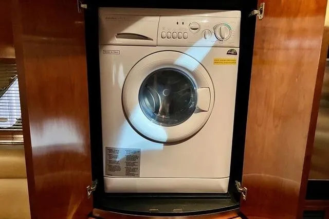 Slide: The Image of Washing machine inside 2009 CRUISERS YACHT 520SC, wooden cabinet enclosure. - 13