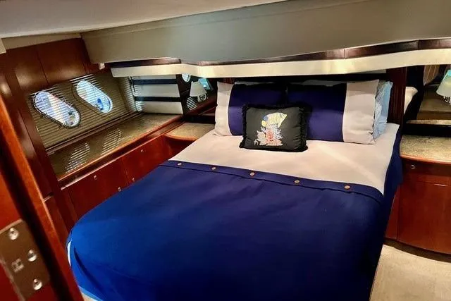 Slide: The Image of Luxurious bedroom interior of 2009 CRUISERS YACHT 520SC with elegant bedding and wood accents. - 14