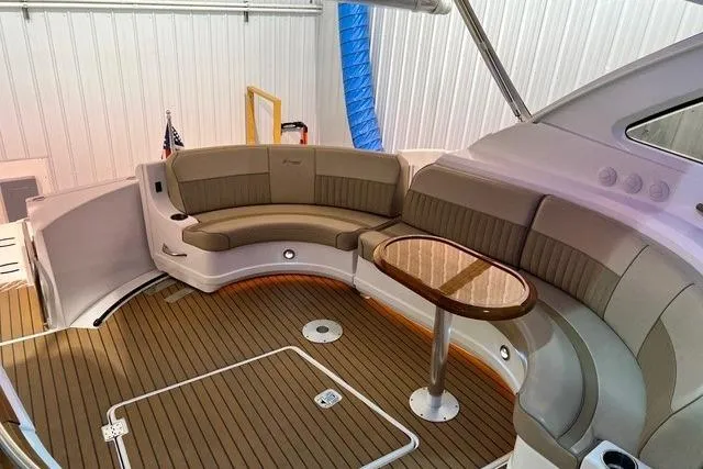 Slide: The Image of 2009 CRUISERS YACHT 520SC interior with curved seating and wooden table. - 17