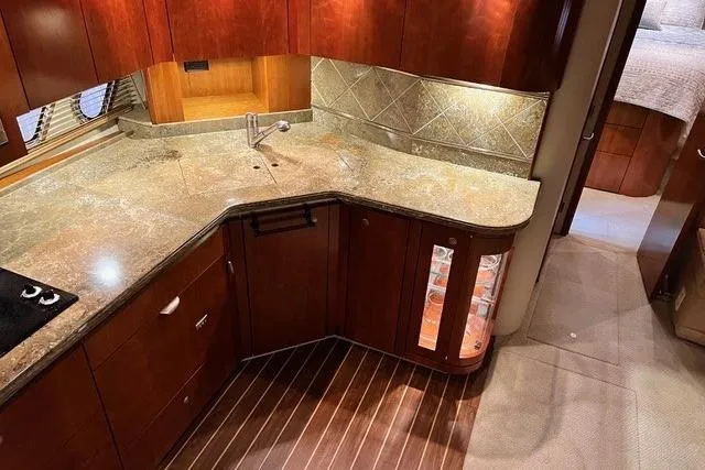 Slide: The Image of Luxurious 2009 CRUISERS YACHT 520SC kitchen with elegant wood cabinetry and granite countertops. - 18