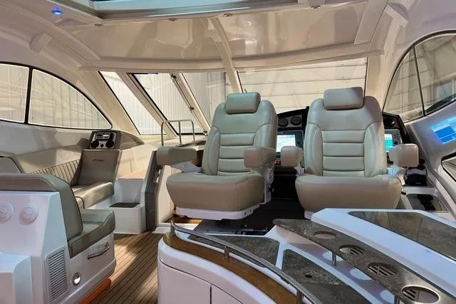 Slide: The Image of Luxurious interior of 2009 CRUISERS YACHT 520SC with plush seating and modern controls. - 19