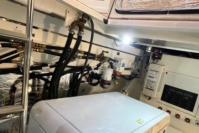 Slide: The Image of Engine room of 2009 CRUISERS YACHT 520SC with visible machinery and wiring. - 22