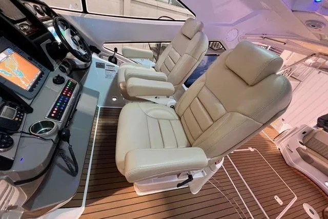 Slide: The Image of Luxurious helm seats on 2009 CRUISERS YACHT 520SC with modern navigation equipment. - 23