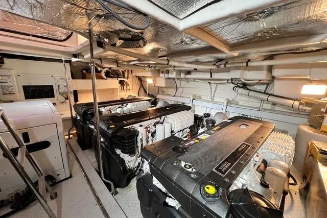 Slide: The Image of Engine room of 2009 CRUISERS YACHT 520SC, featuring dual engines and mechanical components. - 24
