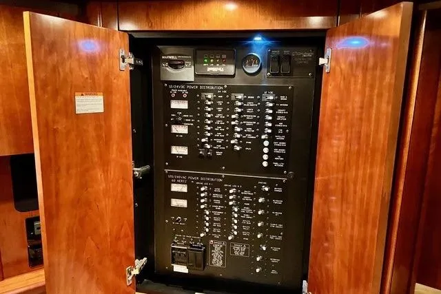 Slide: The Image of Electrical panel inside 2009 CRUISERS YACHT 520SC, showcasing power distribution controls. - 9