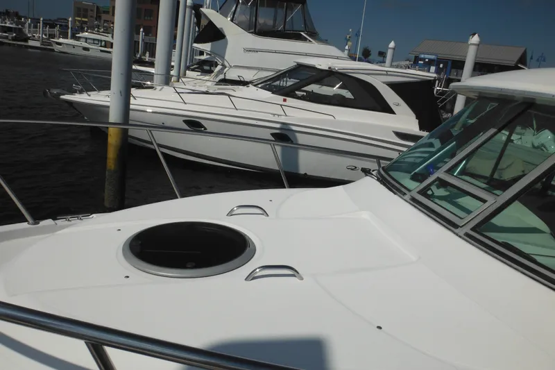 Slide: The Image of 2005 Seaswirl Striper 2901 Walkaround O/B docked at marina, alongside other boats. - 12