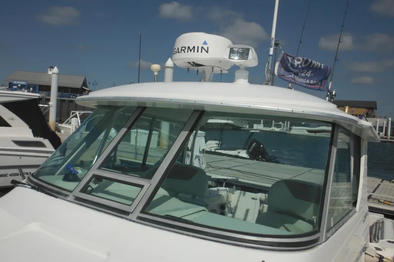 Slide: The Image of 2005 Seaswirl Striper 2901 Walkaround O/B docked, featuring Garmin equipment and fishing rods. - 13