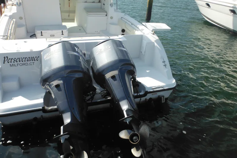 Slide: The Image of 2005 Seaswirl Striper 2901 Walkaround O/B with dual outboard motors docked in water. - 14