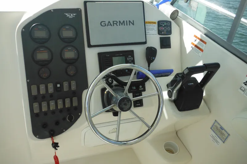Slide: The Image of 2005 Seaswirl Striper 2901 Walkaround O/B helm with Garmin navigation and Yamaha controls. - 16