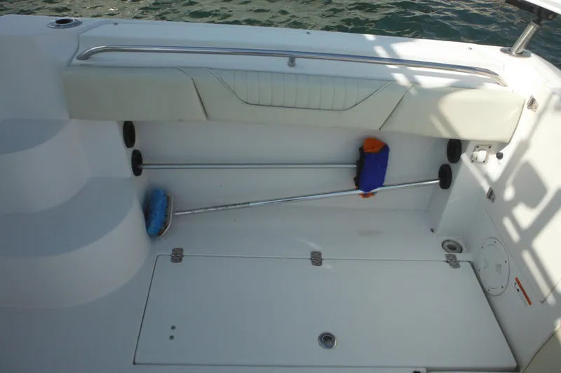 Slide: The Image of 2005 Seaswirl Striper 2901 Walkaround O/B deck with cleaning tools and storage. - 19