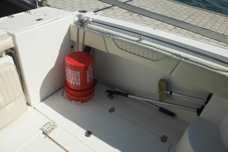 Slide: The Image of 2005 Seaswirl Striper 2901 Walkaround O/B interior with red bucket and boat equipment. - 21