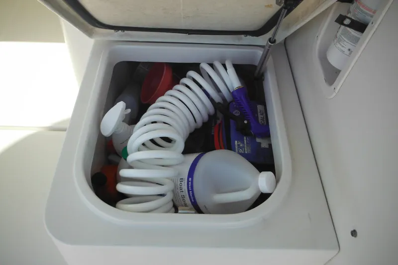 Slide: The Image of Storage compartment on 2005 Seaswirl Striper 2901 Walkaround O/B with cleaning supplies. - 25