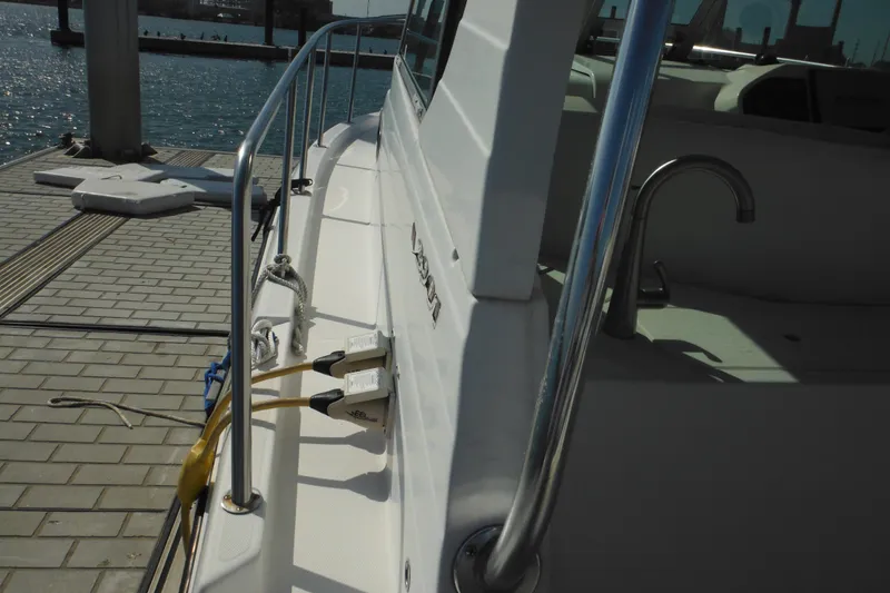 Slide: The Image of 2005 Seaswirl Striper 2901 Walkaround O/B docked, showing deck and railing details. - 27
