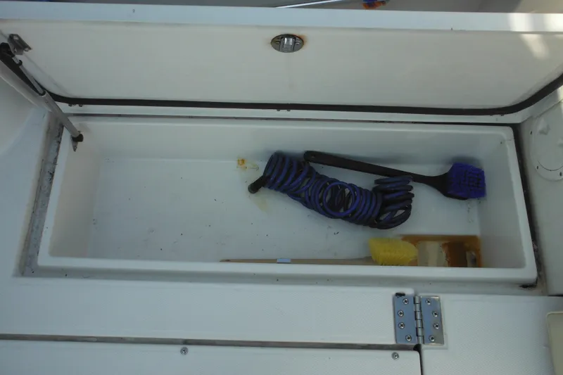 Slide: The Image of Storage compartment on 2005 Seaswirl Striper 2901 Walkaround O/B with cleaning tools inside. - 29