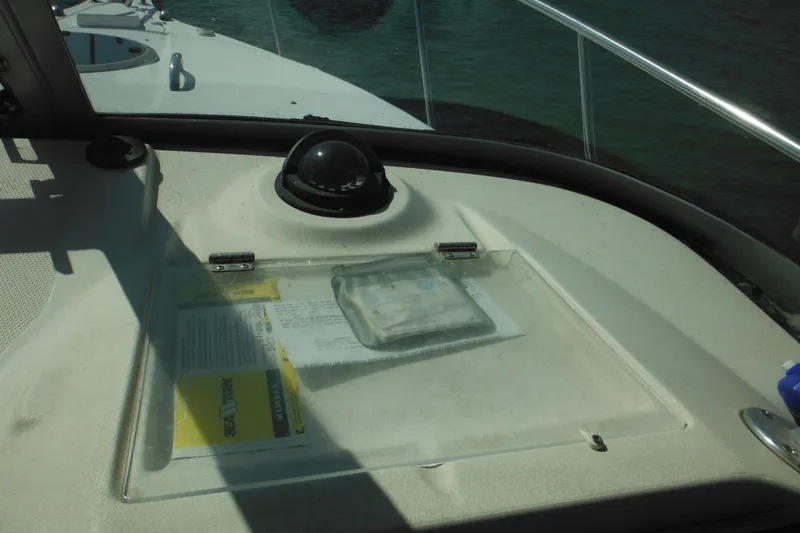 Slide: The Image of 2005 Seaswirl Striper 2901 Walkaround O/B dashboard with compass and documents. - 38