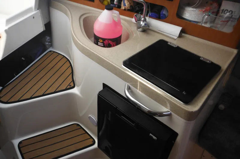 Slide: The Image of 2005 Seaswirl Striper 2901 Walkaround O/B boat interior with sink and storage. - 41