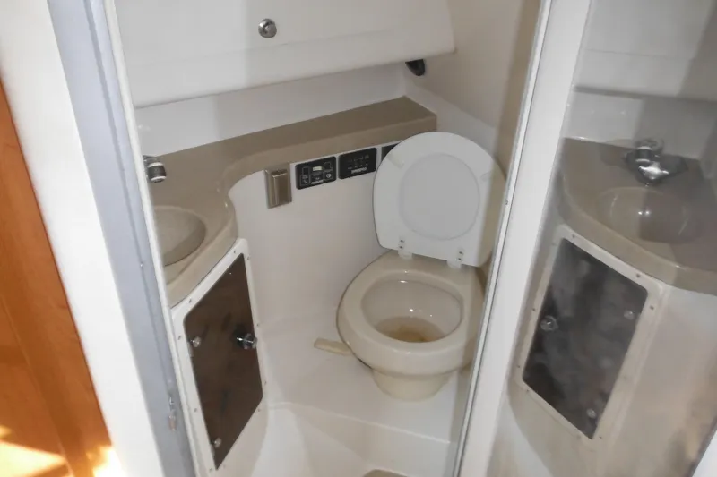 Slide: The Image of 2005 Seaswirl Striper 2901 Walkaround O/B boat bathroom with toilet and sink. - 42
