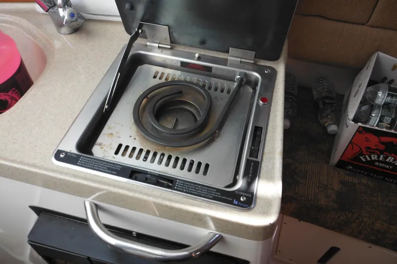 Slide: The Image of 2005 Seaswirl Striper 2901 Walkaround O/B boat stove with coiled burner. - 49