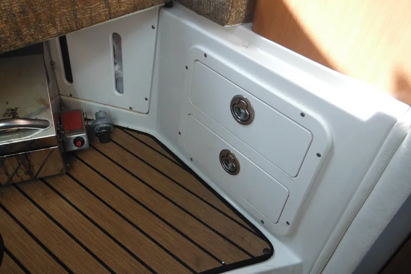 Slide: The Image of 2005 Seaswirl Striper 2901 Walkaround O/B interior with storage compartments and wood flooring. - 50