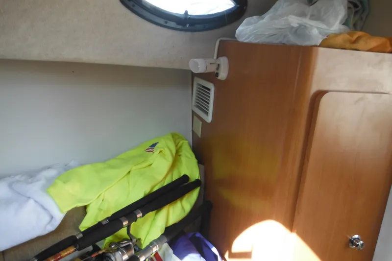 Slide: The Image of Interior of 2005 Seaswirl Striper 2901 Walkaround O/B with fishing gear and clothing. - 51
