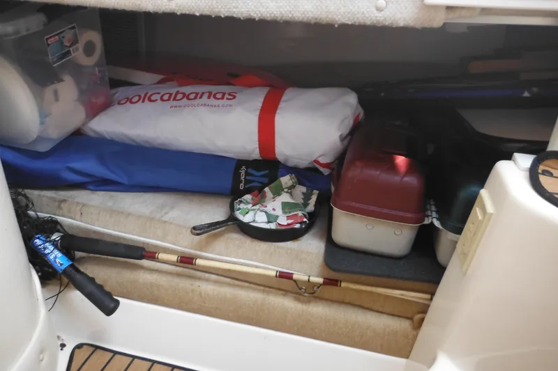Slide: The Image of Storage area in a 2005 Seaswirl Striper 2901 Walkaround O/B with fishing gear and supplies. - 52