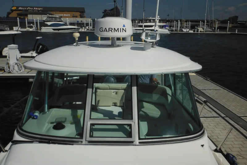 Slide: The Image of 2005 Seaswirl Striper 2901 Walkaround O/B docked, featuring Garmin equipment. - 55