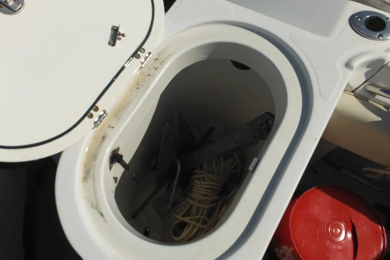 Slide: The Image of Open storage compartment on 2005 Seaswirl Striper 2901 Walkaround O/B with rope and anchor. - 62