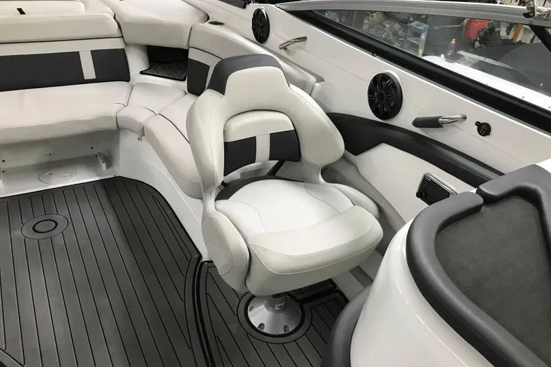 Slide: The Image of 2018 Rinker QX26 BR boat interior with white seating and black accents. - 12
