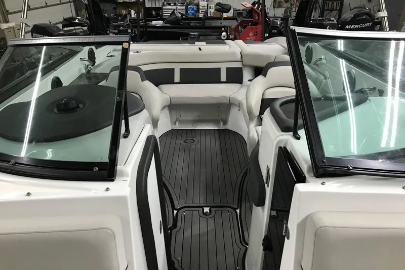 Slide: The Image of 2018 Rinker QX26 BR boat interior with sleek seating and modern design. - 13