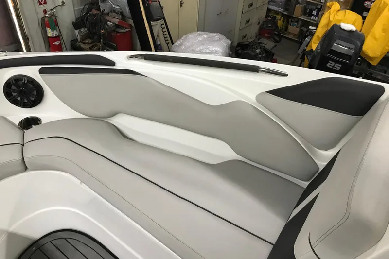 Slide: The Image of 2018 Rinker QX26 BR boat interior with sleek seating and speaker system. - 17