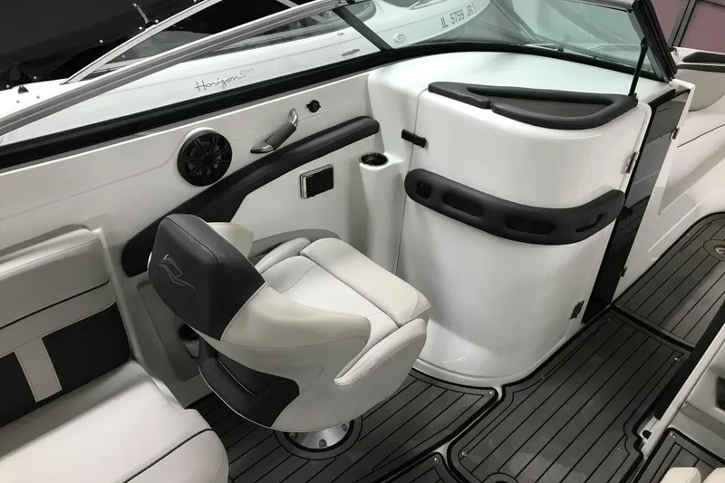Slide: The Image of 2018 Rinker QX26 BR boat interior with swivel seat and modern dashboard. - 19