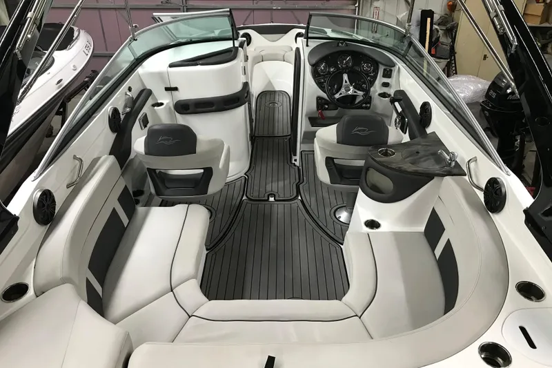 Slide: The Image of 2018 Rinker QX26 BR boat interior with sleek seating and modern dashboard design. - 23