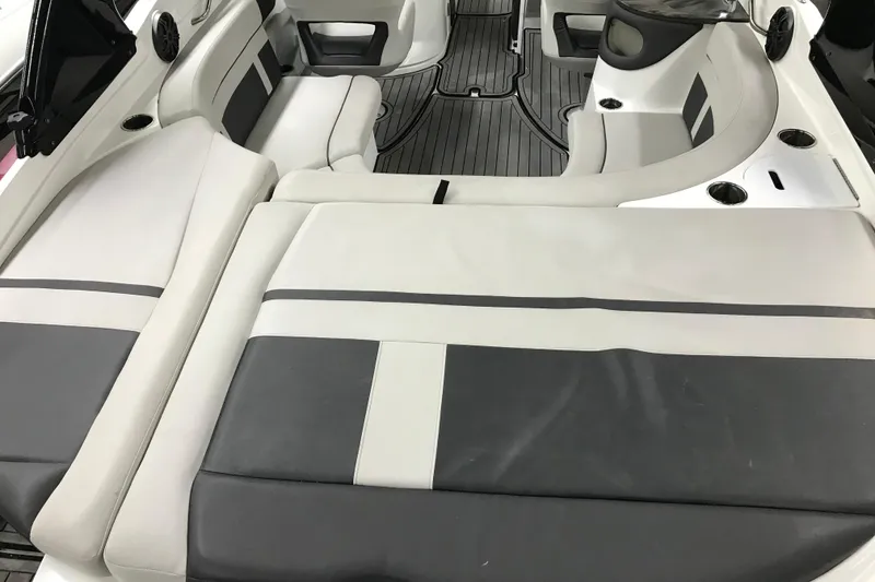 Slide: The Image of 2018 Rinker QX26 BR boat interior with gray and white seating. - 24