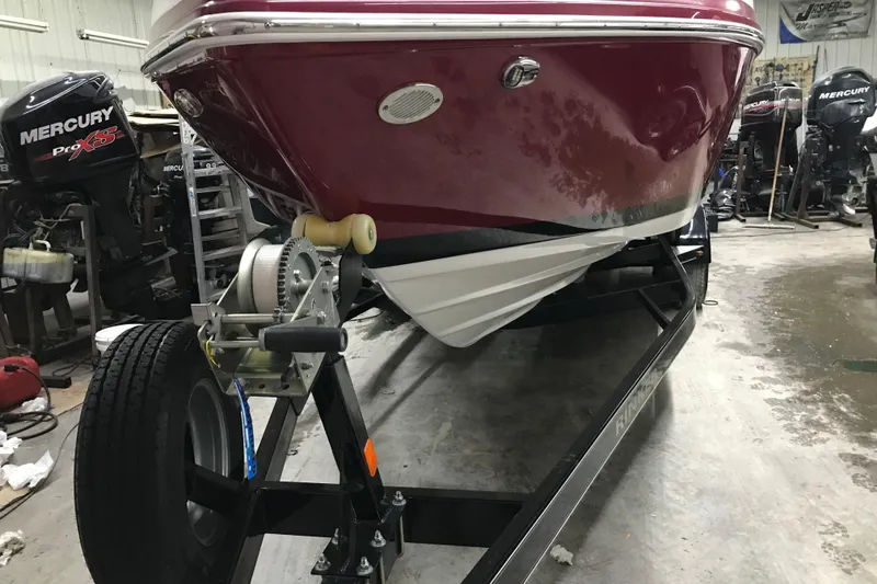 Slide: The Image of 2018 Rinker QX26 BR boat on trailer in garage with Mercury engines. - 32