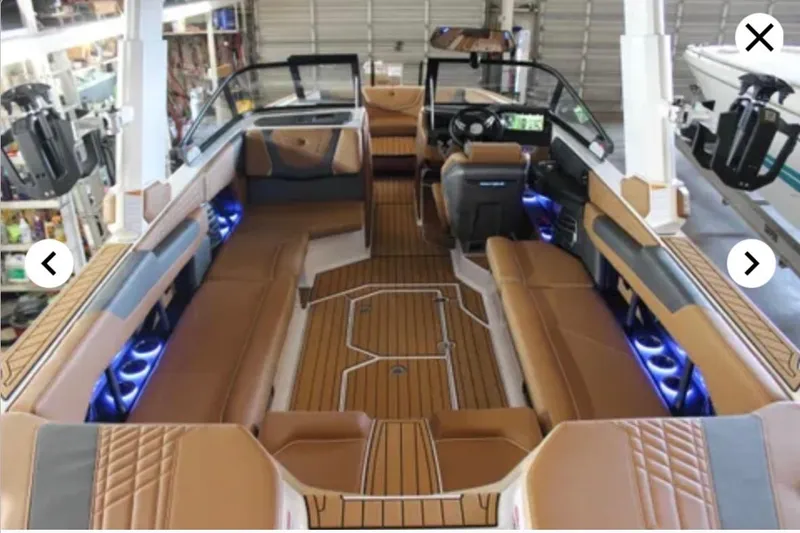 Slide: The Image of 2024 Nautique Super Air Nautique G25 interior with luxurious seating and ambient lighting. - 4