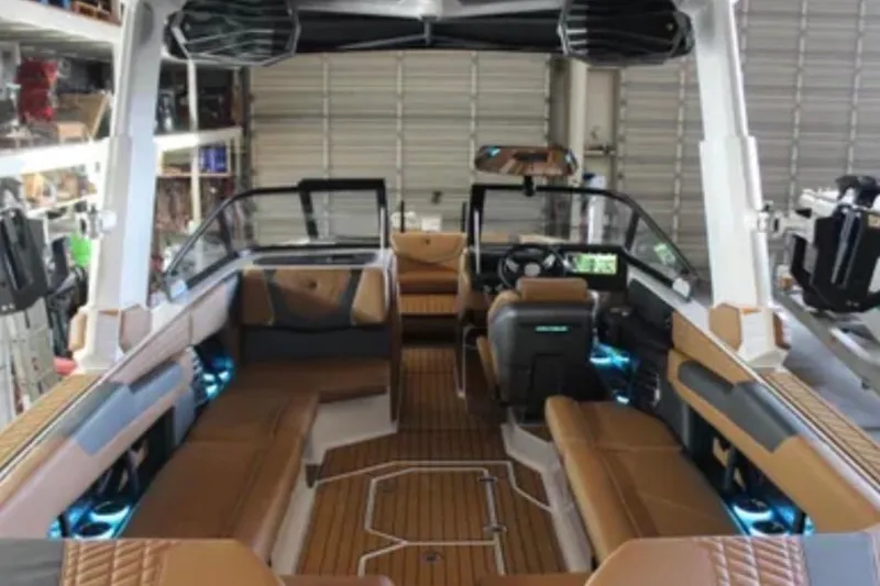Slide: The Image of 2024 Nautique Super Air Nautique G25 interior with luxurious seating and modern dashboard. - 5