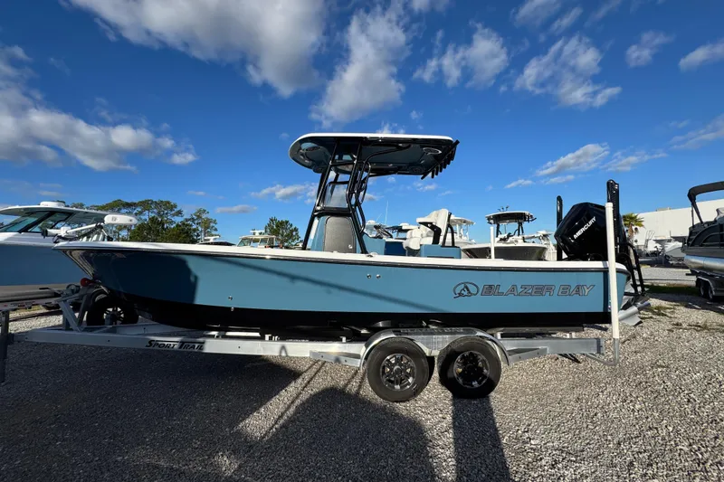 The Image of 2025 Blazer Bay 2700 Hybrid boat on trailer under blue sky. - 1