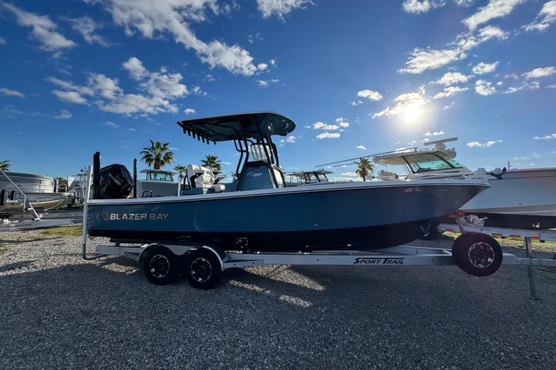 Slide: The Image of 2025 Blazer Bay 2700 Hybrid boat on trailer under sunny sky. - 10