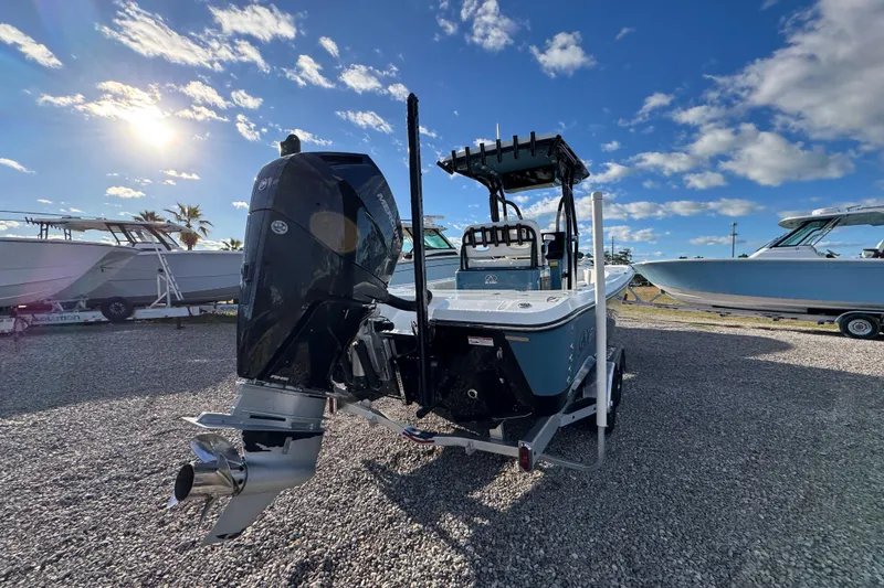 Slide: The Image of 2025 Blazer Bay 2700 Hybrid boat with powerful outboard motor under sunny sky. - 14