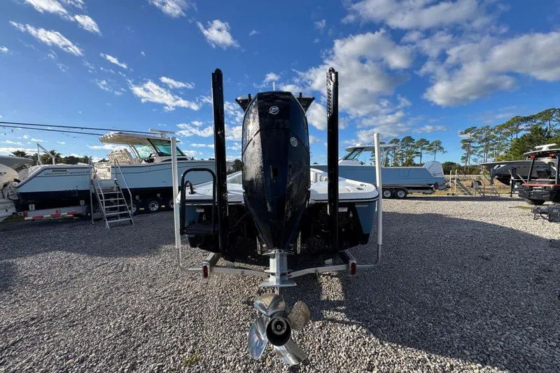 Slide: The Image of 2025 Blazer Bay 2700 Hybrid boat on gravel lot under blue sky. - 15