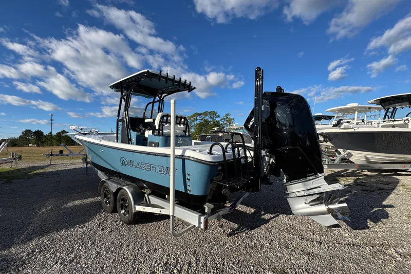 Slide: The Image of 2025 Blazer Bay 2700 Hybrid boat on trailer under blue sky. - 18