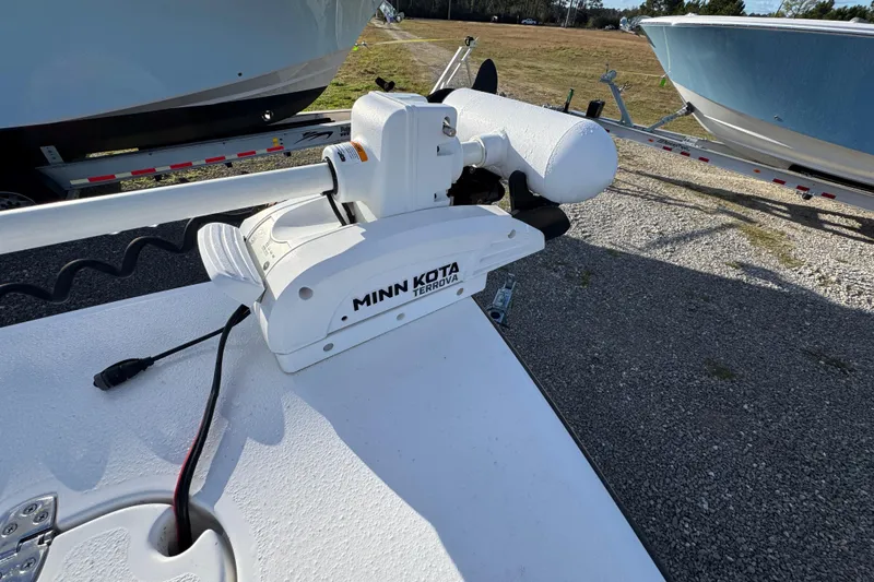 Slide: The Image of Minn Kota Terrova motor on 2025 Blazer Bay 2700 Hybrid boat, parked on gravel. - 22