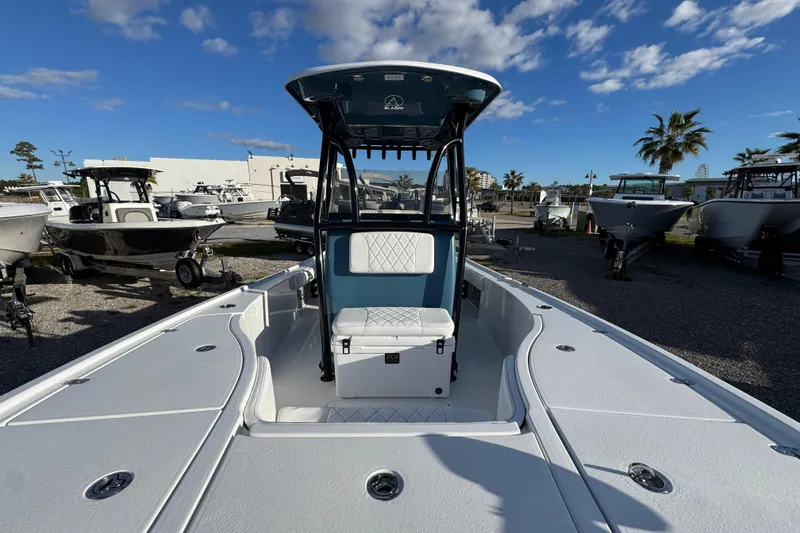 Slide: The Image of 2025 Blazer Bay 2700 Hybrid boat in a sunny marina setting. - 25