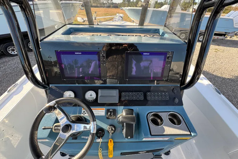 Slide: The Image of 2025 Blazer Bay 2700 Hybrid boat dashboard with dual screens and steering wheel. - 33