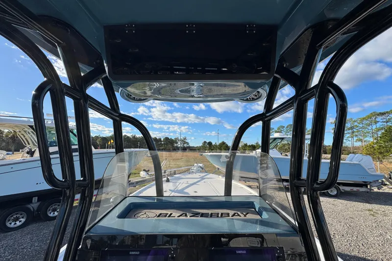 Slide: The Image of 2025 Blazer Bay 2700 Hybrid boat interior with clear sky and surrounding boats. - 34