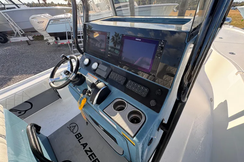 Slide: The Image of 2025 Blazer Bay 2700 Hybrid boat dashboard with steering wheel and navigation system. - 35