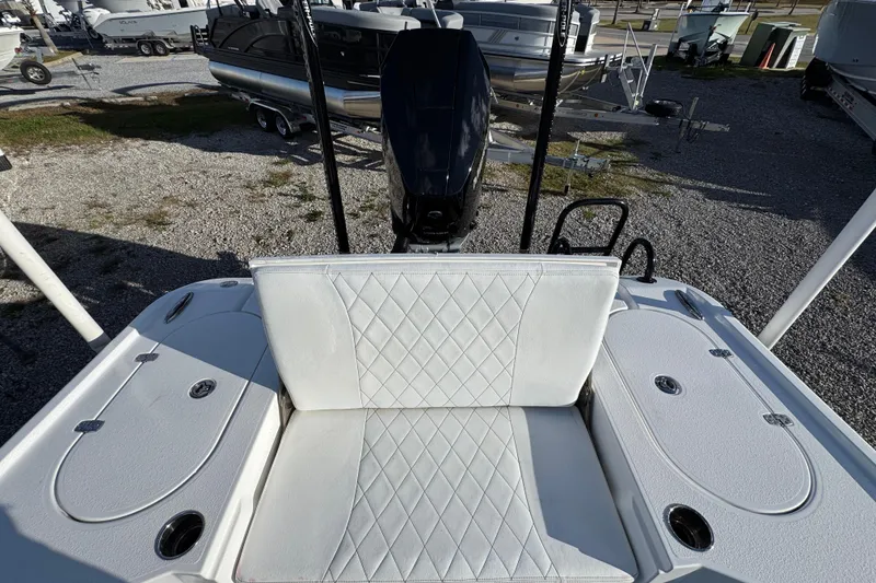Slide: The Image of 2025 Blazer Bay 2700 Hybrid boat with white seating and outboard motor. - 39