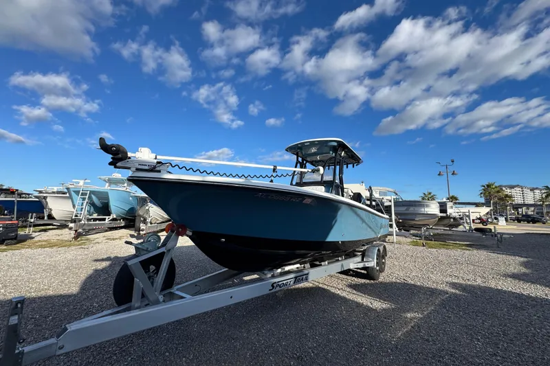 Slide: The Image of 2025 Blazer Bay 2700 Hybrid boat on trailer under blue sky. - 4