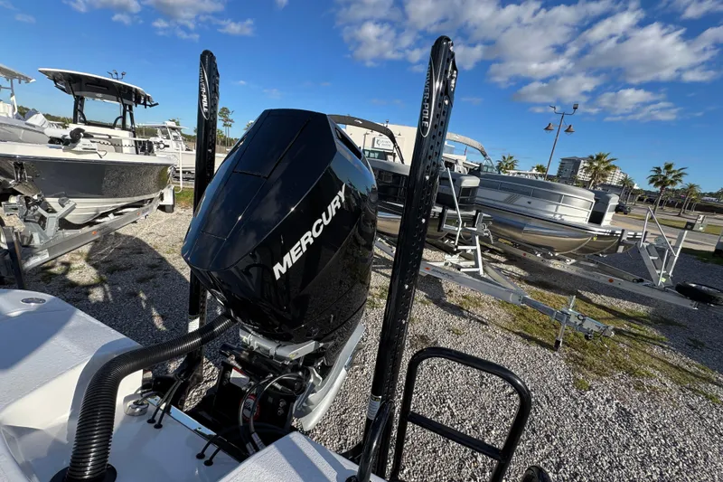 Slide: The Image of 2025 Blazer Bay 2700 Hybrid boat with Mercury engine, parked on gravel lot. - 40